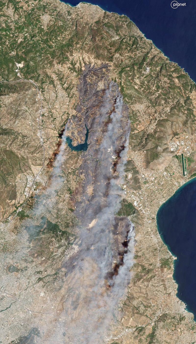 A satellite image showed smoke rising from wildfires in East Attica, some 22 miles north of Athens (Planet Labs PBC via AP)