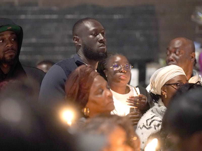 Stormzy (centre) joined people attending a vigil outside the Whitgift shopping centre