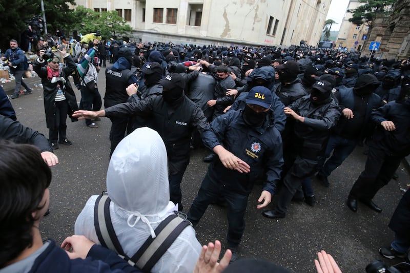 Police block demonstrators near the parliament building during an opposition protest against ‘the Russian law’ in the centre of Tbilisi, Georgia (Zurab Tsertsvadze/AP)