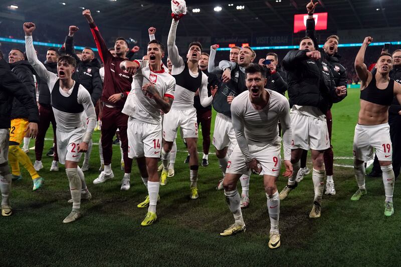 Poland’s Robert Lewandowski, Jakub Kiwior and team-mates celebrate after winning the penalty shoot-out