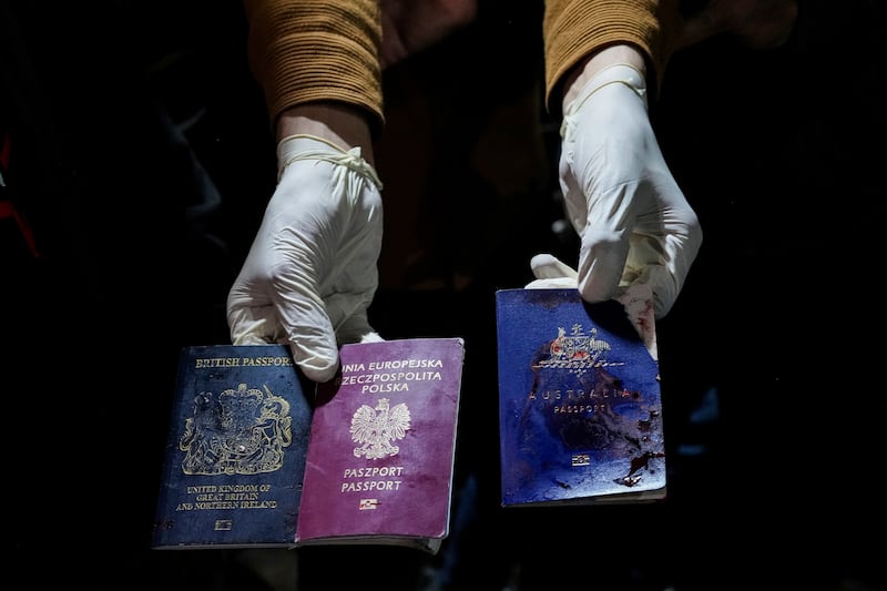 A man holds blood-stained British, Polish, and Australian passports after an Israeli airstrike, in Deir al-Balah, Gaza Strip killed at least seven international aid workers with the World Central Kitchen charity and their Palestinian driver (AP Photo/Abdel Kareem Hana)