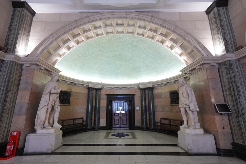 Statues of William IV holding a scroll (left) and William III holding an orb, at the whispering gallery in the Old Bailey, said to be constructed so that one person can whisper a secret from one side and be heard on the other due to its unusual acoustics