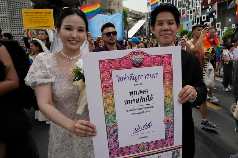 Participants hold posters celebrating equality in marriage during a Pride Parade in Bangkok in June (AP Photo/Sakchai Lalit, File)