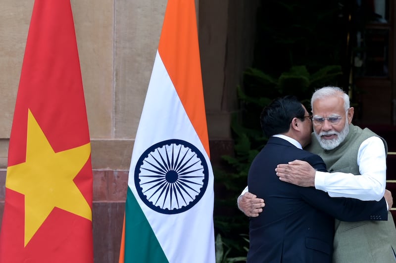 Indian Prime Minister Narendra Modi, right, receives his Vietnamese counterpart Pham Minh Chinh as the latter arrives for talks in New Delhi, India (AP)