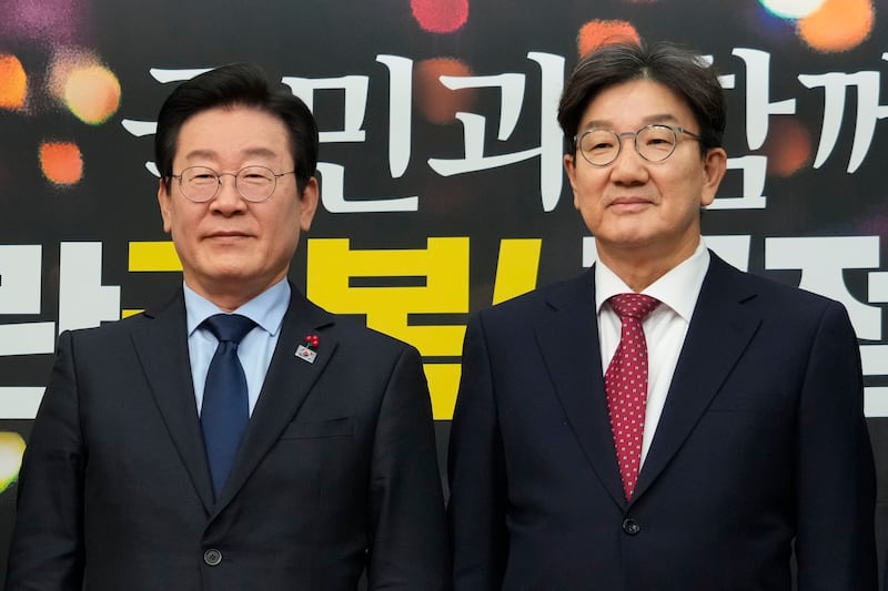 South Korea’s main opposition Democratic Party leader Lee Jae-myung, left, and Kweon Seong-dong, floor leader and interim chairperson of the ruling People Power Party (AP/Ahn Young-joon)