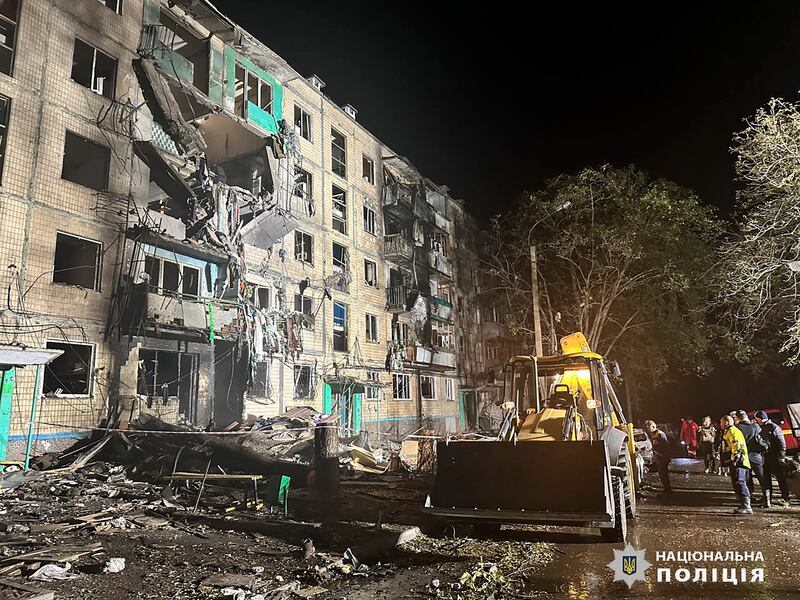 People gather after a Russian strike on a residential building in Kharkiv (Ukrainian National Police via AP)