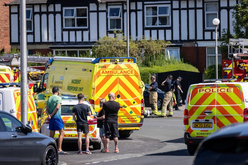 Locals watch on as ambulances and police attend the scene after two children were killed and six others were left critical after a knife attack in Southport.