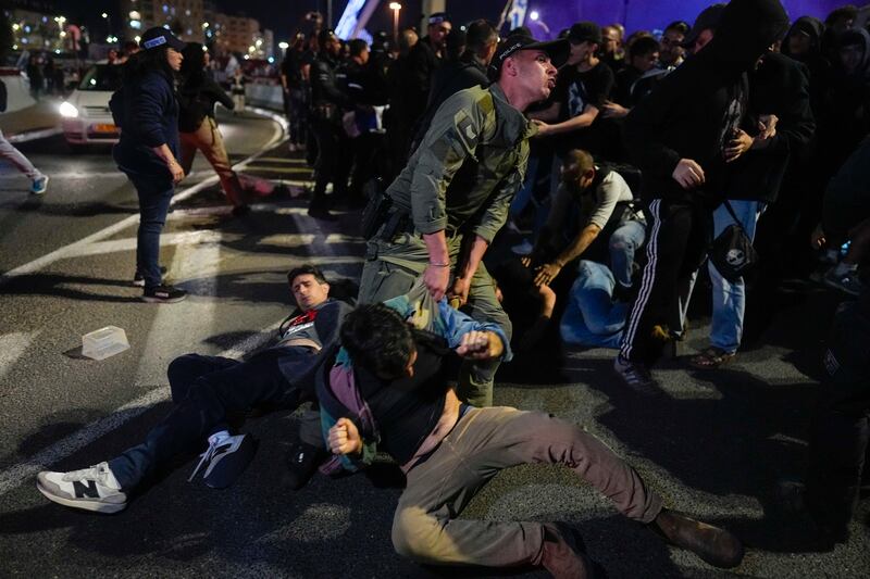 Police drag away protesters (Ohad Zwigenberg/AP)