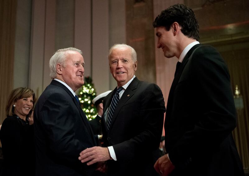 Former Canadian prime minister Brian Mulroney, left, greets then-US vice president Joe Biden and Canadian Prime Minister Justin Trudeau as they arrive at a state dinner in in Ottawa 2016 (Justin Tang/The Canadian Press via AP)