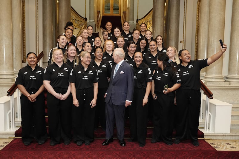 Charles has his photo taken with New Zealand’s Black Ferns rugby union team on the Grand Staircase at Buckingham Palace