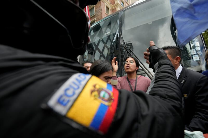 A protester argues with a police officer in Quito, Ecuador (AP Photo/Dolores Ochoa)