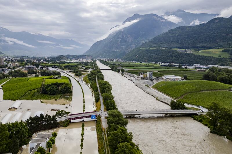 The Rhone river overflows in Sierre, Switzerland, following storms (Jean-Christophe Bott/Keystone/AP)