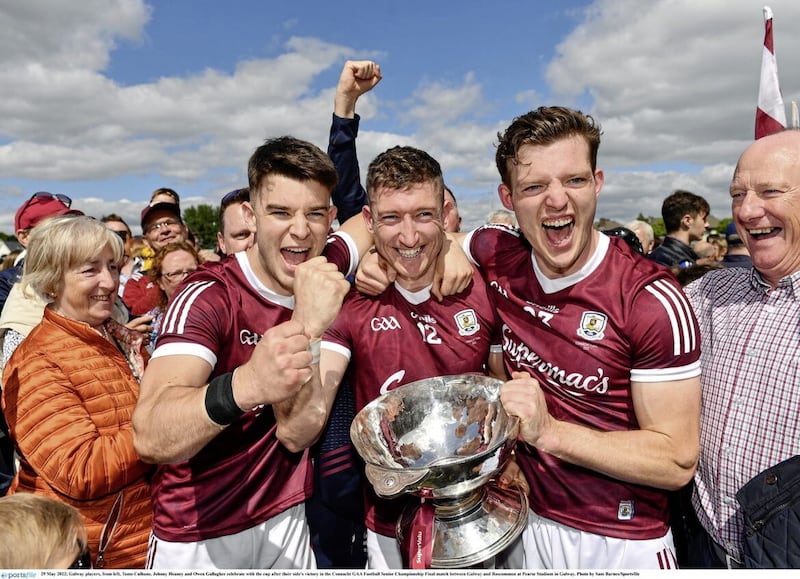 Galway players Tomo Culhane, Johnny Heaney, and Owen Gallagher celebrate beating Roscommon in the 2022 Connacht SFC Final at Pearse Stadium