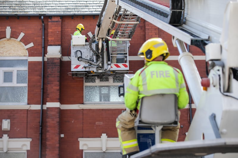 Merseyside Fire and Rescue service repair a broken window at Southport Islamic Centre Mosque