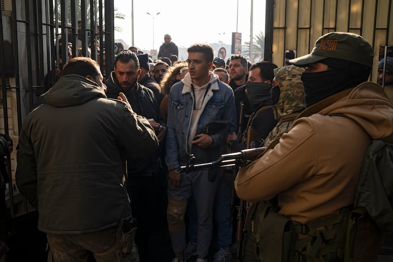 Members of Bashar Assad’s army are being questioned (Leo Correa/AP)