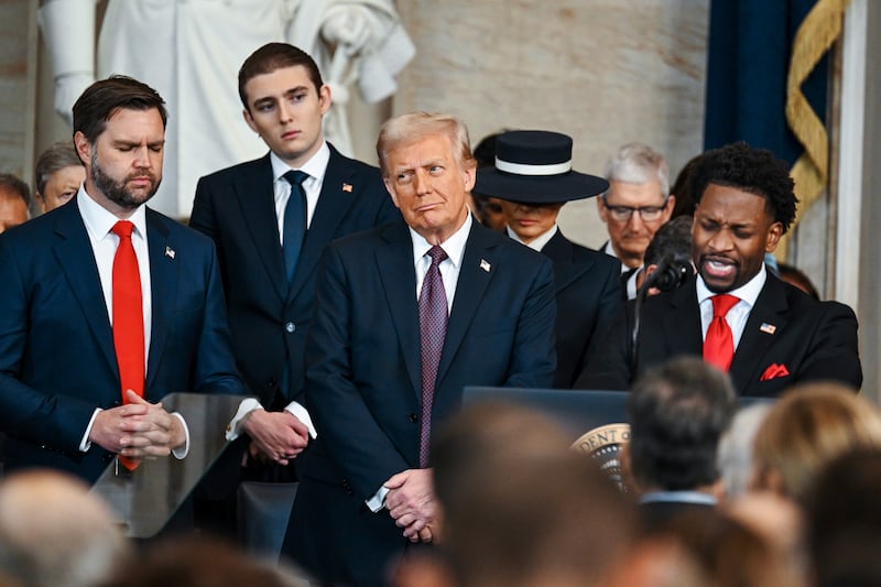 Senior Pastor Lorenzo Sewell speaks as President Donald Trump, Barron Trump and Vice President JD Vance listen (Kenny Holston/The New York Times via AP)