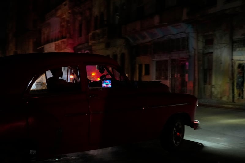 A man drives his American classic car during a massive blackout after a major power plant failed in Havana, Cuba (Ramon Espinosa/AP)