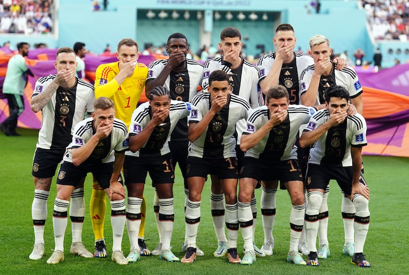 German players covered their mouths in protest at being blocked from wearing the OneLove armband in Qatar