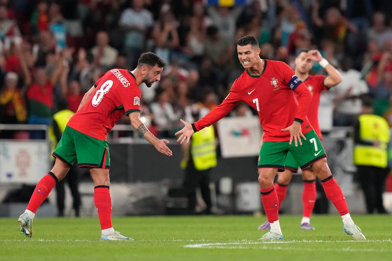 Bruno Fernandes celebrates with Cristiano Ronaldo (AP Photo/Armando Franca)