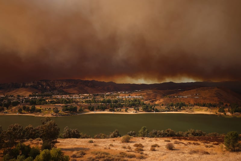 Plumes of smoke caused by the Hughes Fire rise over Castaic, California (Ethan Swope/AP)