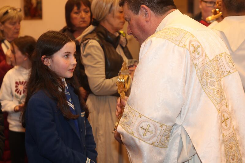 Downpatrick deacon, Jackie Breen, blessing 12-year-old Tierna McLoughlin from Leitrim with the relic of Blessed Carlo Acutis on its visit to St Nicholas' Church in Ardglass, Co Down (Bill Smyth)