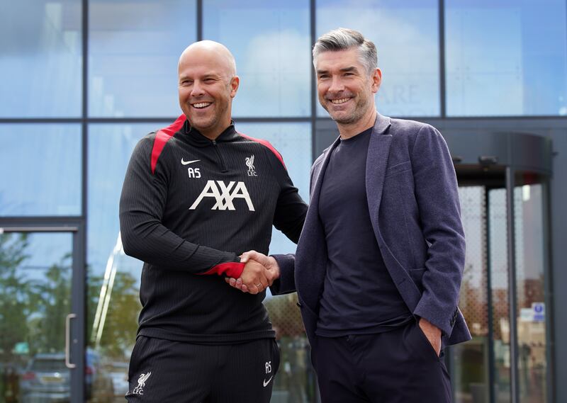 Arne Slot (left) speaks regularly with sporting director Richard Hughes (right)