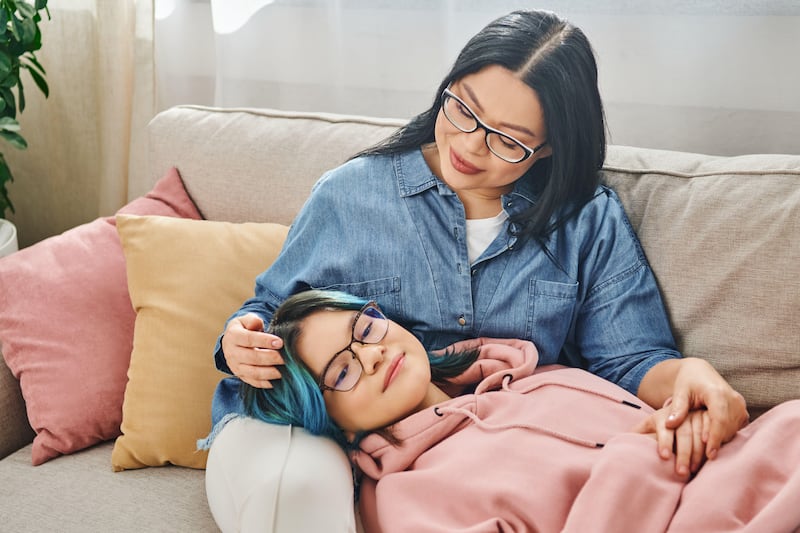 If you stay calm your child will feel more relaxed  side by side on a couch in casual clothes.