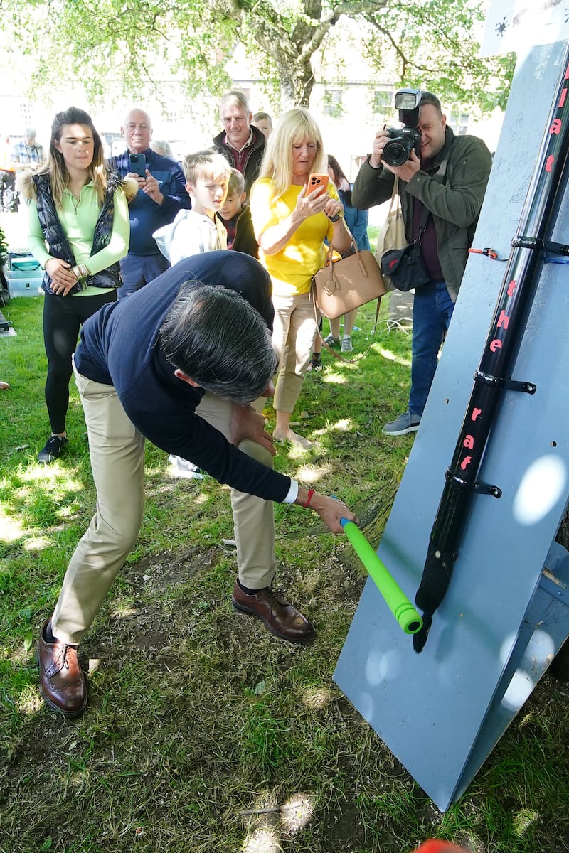 Prime Minister Rishi Sunak playing Splat the Rat at a village fete in Great Ayton, Yorkshire, while on the General Election campaign trail