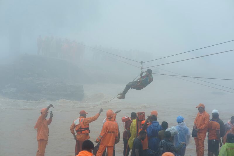 Rescuers try to reach affected people after landslides hit hilly villages in Wayanad district (AP Photo)