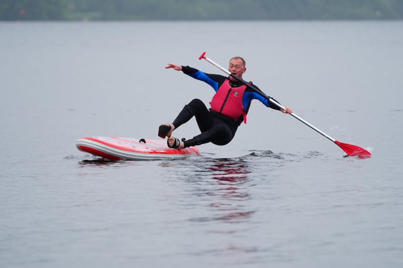 Local Liberal Democrat candidate Tim Farron falls in while paddleboarding on Windermere