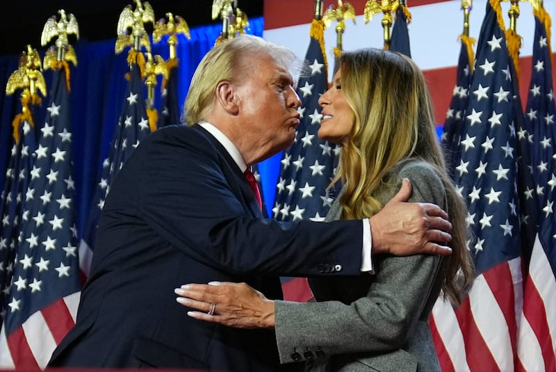 Donald Trump kisses former first lady Melania Trump at an election night watch party at the Palm Beach Convention Centre in Florida (Evan Vucci/AP)