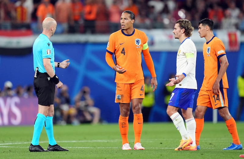 Taylor speaks to Dutch and French players during the VAR check