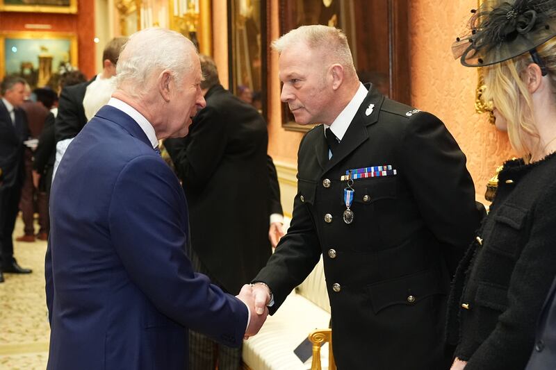 Constable Zachary Printer, Devon and Cornwall Police, shakes hands with the King as he receives the King’s Gallantry Medal