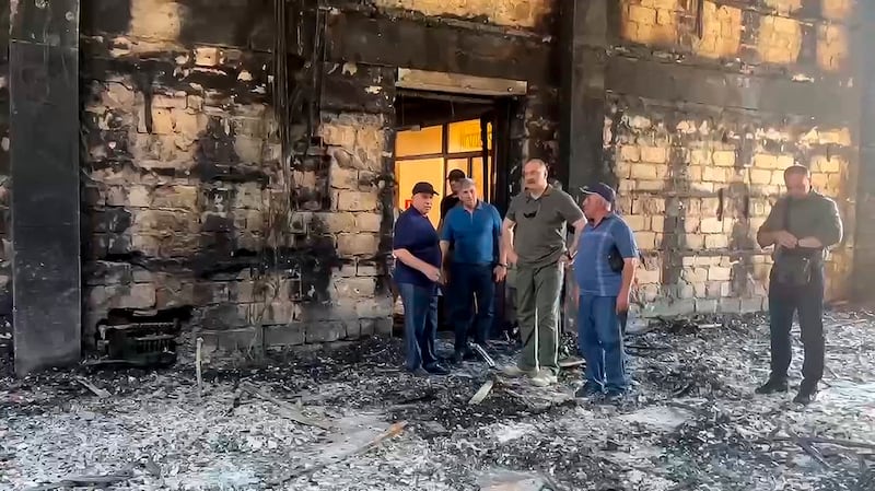 Dagestan governor Sergei Melikov, centre, visits the damaged the Kele-Numaz synagogue in Derbent (The Telegram Channel of the head of Dagestan Republic of Russia via AP)
