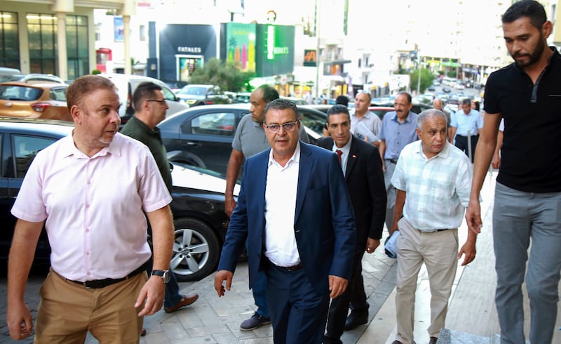 Tunisian presidential candidate Zouhair El Maghzaoui meets Tunis residents during his campaign tour (Anis Mili/AP)