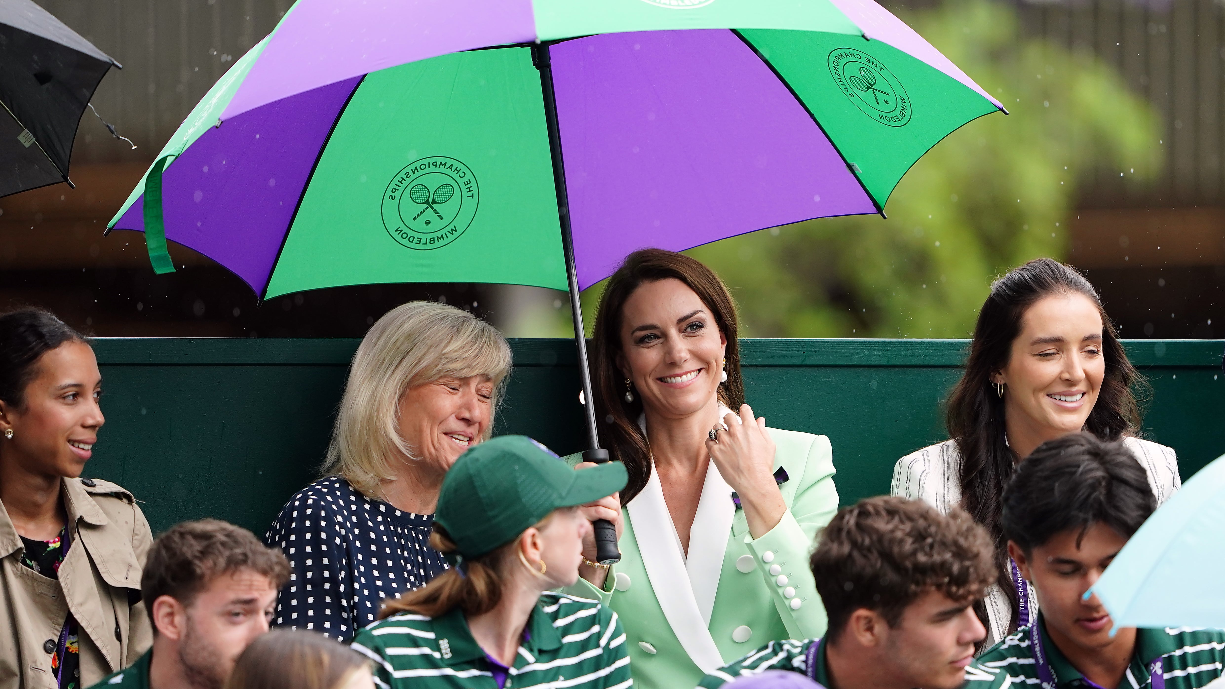 A large umbrella is an essential for every attendee – even the Princess of Wales