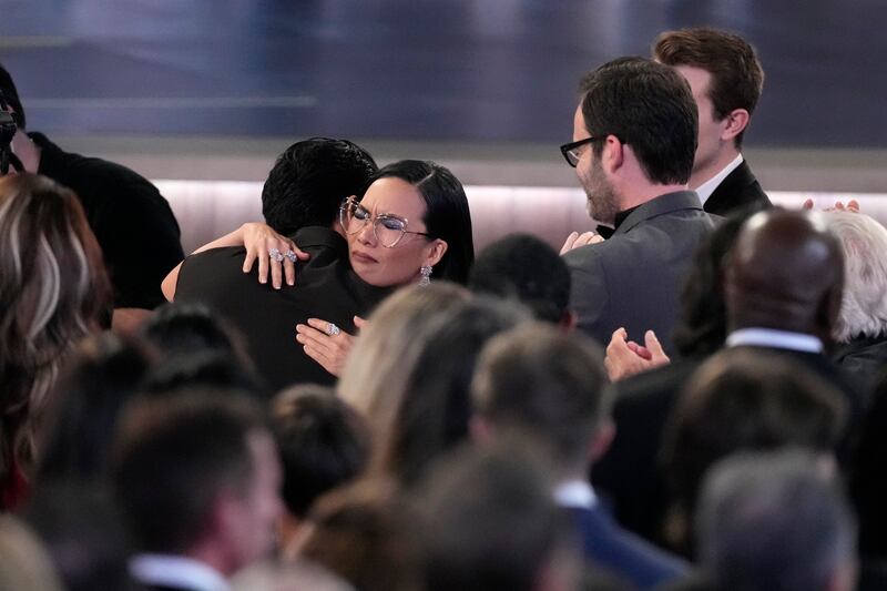 Ali Wong, left, embraces Steven Yeun after he wins the award for outstanding lead actor in a limited or anthology series or movie for Beef (Chris Pizzello/AP)