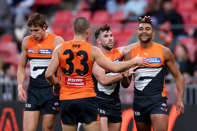 SYDNEY, AUSTRALIA - JUNE 16: Callum M. Brown of the Giants celebrates kicking a goal with team mates during the round 14 AFL match between Greater Western Sydney Giants and Port Adelaide Power at ENGIE Stadium, on June 16, 2024, in Sydney, Australia. (Photo by Brendon Thorne/AFL Photos/via Getty Images)