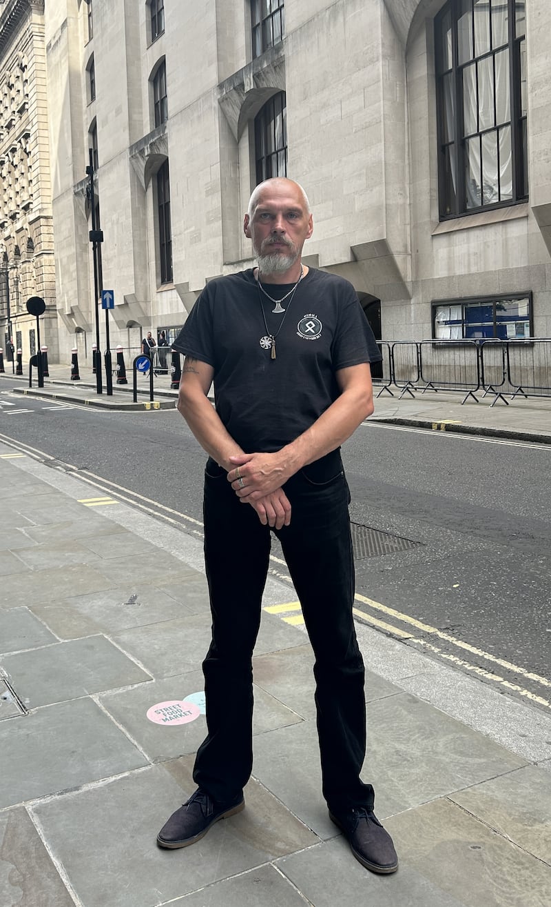 Piotr Kucharski posed for a photo for a reporter from the PA news agency while wearing the symbols