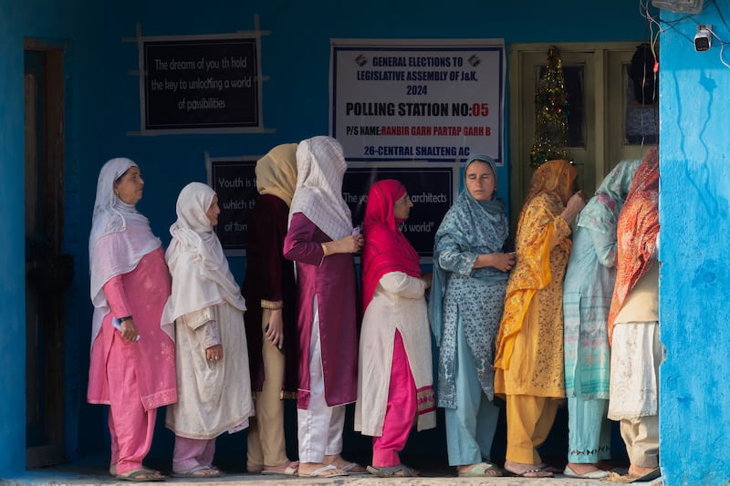 Kashmiri women queue up at a polling booth on the outskirts of Srinagar (Dar Yasin/AP)