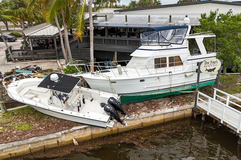 Boats rest beside a restaurant after being pushed up by floodwaters from Hurricane Helene in St Petersburg, Florida (AP Photo/Mike Carlson)