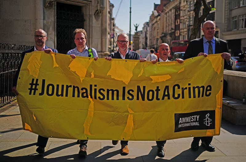 Supporters of journalists Barry McCaffrey and Trevor Birney, outside the Royal Courts of Justice in London, before their Investigatory Powers Tribunal