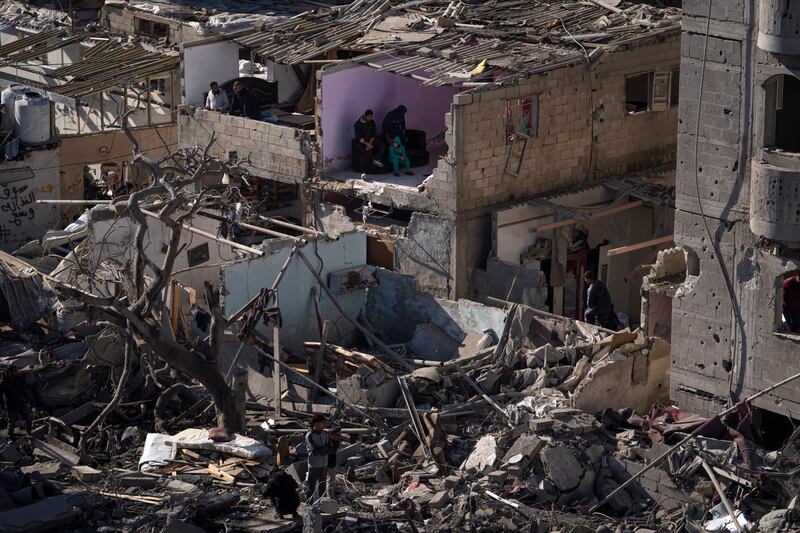 Palestinians look at the destruction after an Israeli strike on residential buildings and a mosque in Rafah, Gaza Strip (Fatima Shbair/AP)