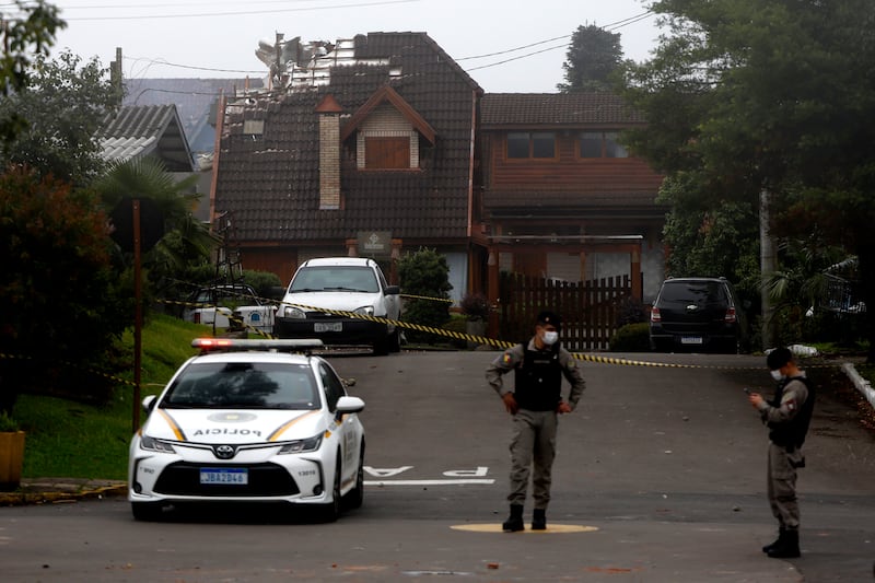 Police cordon off houses that were hit by a plane in Gramado, Rio Grande do Sul State, Brazil (Mateus Bruxel, Agencia RBS/AP)