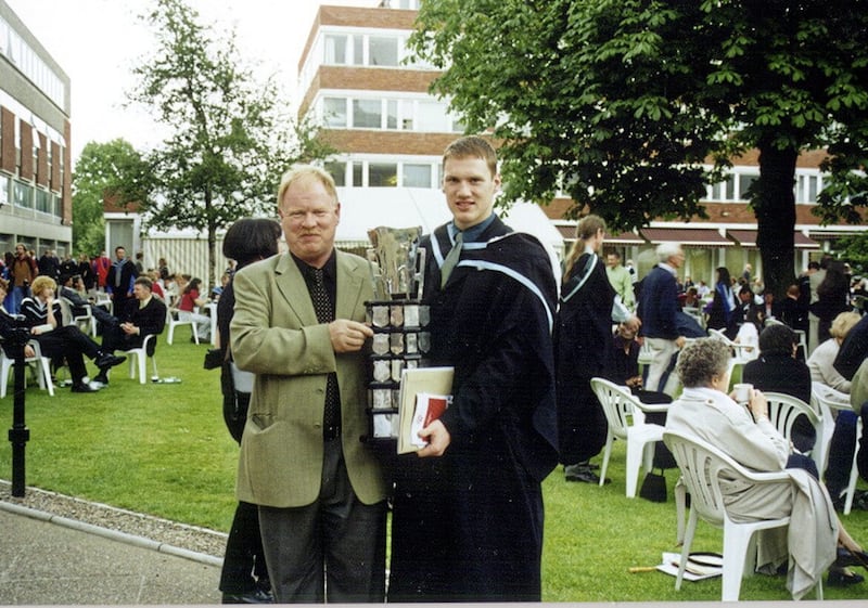 Brendan McAnallen with his son Cormac and the Sigerson Cup on his graduation day at Queen&#39;s University in July 2000 