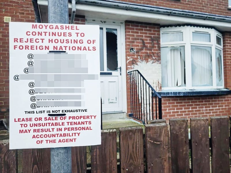 A racist poster outside a home in Moygashel, Co Tyrone with its windows smashed and graffiti sprayed on the walls 