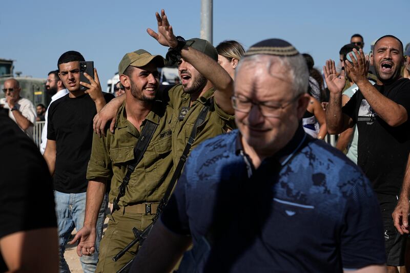 Israeli soldiers going a protest at the gate to Sde Teiman military base, in support of soldiers being questioned for detainee abuse (Tsafrir Abayov/AP)