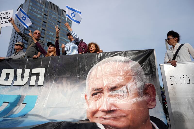 Supporters of Israel’s Prime Minister Benjamin Netanyahu gather outside a court in Tel Aviv, Israel (Ariel Schalit/AP)