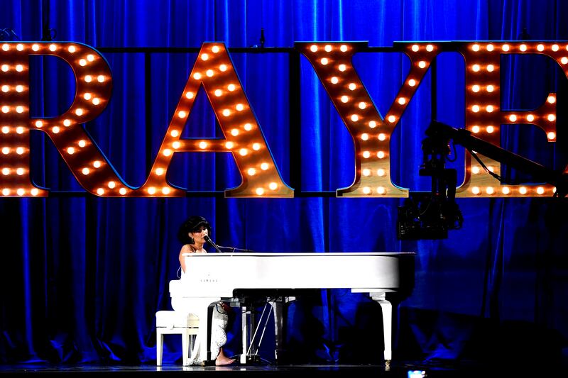 Raye performs on stage during the Brit Awards 2024
