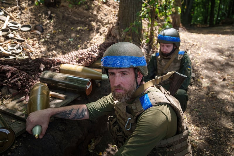 Ukrainian national guard servicemen of Khartia brigade prepare to reload a D-20 cannon while firing towards Russian positions near Kharkiv (Evgeniy Maloletka/AP)